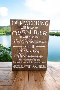 a wooden sign that says our wedding will have an open bar