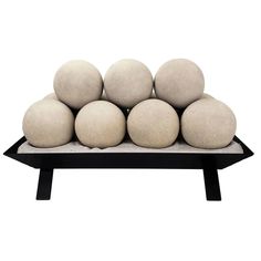 a black and white tray with six balls on it