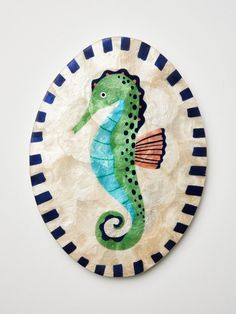 a paper plate with a seahorse painted on it