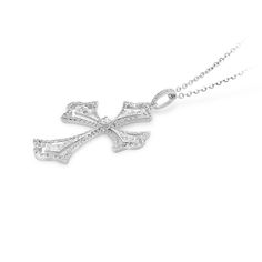 Faith meets fashion in this stylish diamond pave cutout cross pendant. Created in 18K white gold, this design features a polished diamond embellished scalloped-edged cross with a brilliant cut round sparkling diamond tying the design together.  A fashionable look she'll adore and wear daily as well as on special occasions. The perfect gift for an anniversary. 
0.65 carat pave setting
18k white gold
We offer a Free virtual Consultation from the comfort of your home so that you can Diamond White Diamond Cross Necklace For Anniversary, White Gold Diamond Cross Necklace For Wedding, Diamond White Diamond Cross Necklace, Silver Diamond Cross Necklace For Anniversary, Formal White Gold Cross Necklace With Diamond Cut, Diamond White Cross Necklace With Diamond Accents, Diamond Cross Necklace With Accents For Anniversary, White Gold Cross Necklace With Brilliant Cut Cubic Zirconia, Diamond Cross Pendant Necklace For Wedding