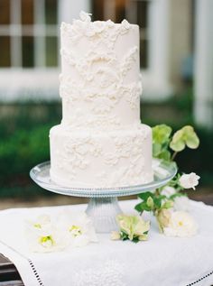 a white wedding cake sitting on top of a table