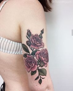 a woman's arm with pink roses on it and the words flowerpor no name tattoo shop