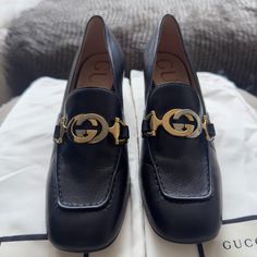 Gucci Malaga Kid Leather Loafer In Black Like-New Gucci Loafer In Clean Black With Iconic Gucci Two-Tone Hardware With Subtle And Elegant Rectangle Toe With A Low Height Heel. Condition: Very Good; Used 1-2x, Some Wear On Soles, No Scuffs Or Marks On Exterior Leather Or Scratches On Hardware. *Size: Us 5 / 35 It/Eu *Heel: 2.5" Approx. *Material: Leather Exterior, Leather Interior *Made In Italy Comes With Original Gucci Silk Shoe Bags. Note: These Are Women’s Loafers, Not Kids, Despite The Name Gucci Black Loafers For Work, Designer Calf Leather Loafers For Work, Chic Gucci Loafers For Formal Occasions, Chic Gucci Formal Loafers, Gucci Black Square Toe Heels, Designer Gucci Loafers For Work, Gucci Elegant Loafers For Office, Gucci Elegant Office Loafers, Elegant Gucci Loafers For Office