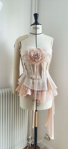 A unique piece handmade by a stylist at Noumène in Paris. Instagram: @noumene_officiel Size fr36-fr38 with 4 levels of hooks. The removable bodice on the corset or like the necklace with the link included. The 3 layers of asymmetrical ruffles with tweed, tulle, crepe fabrics. the shoulder straps are adjustable. Natural and artistic style with raw edge finish. Tweed Corset, Tweed Fashion, Artistic Style, Bustiers, Crepe Fabric, 3 Layers, Corset Top, Raw Edge, Shoulder Straps