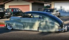 an old car parked in front of a house