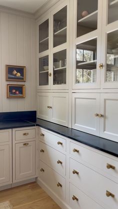 a kitchen with white cabinets and blue counter tops