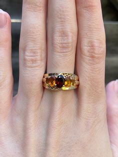 Total Weight: 5.2 grams Size: 9.75 Band Width: 2.9mm-10mm Garnet: approximately 7x5mm Citrine: approximately 6x4mm & 5x3mm Condition: In great condition showing little wear with no damage.  All gold has been thoroughly checked with an Olympus XRF spectrometer. It is guaranteed 14k gold.  All our jewelry is properly washed and disinfected to ensure customers get clean items with every order.  Returns accepted but may be subjected to a restock fee.  Please message with any questions:) Garnet Gem, Citrine Ring, Estate Jewelry, Rings Statement, Citrine, Garnet, Band Rings, Statement Rings, Jewelry Rings