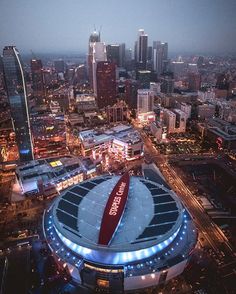 an aerial view of a large stadium in the middle of a city at night time