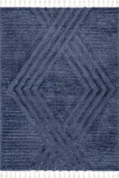 a blue rug with diamond shapes on the top and bottom, in different shades of grey