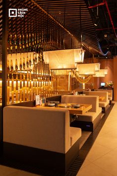 an empty restaurant with tables and chairs in front of a wall full of wine bottles