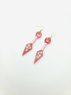 "Beautiful Kunai Earrings with Cherry Blossom accents and ribbon wrapped handles. Will take your cosplay up a notch. Anime lovers will love them. About 2\" long. Can be made in other colors just message me. Earrings are on gold tone hypoallergenic wires." Adjustable Pink Jewelry For Cosplay, Japanese Earrings, Earrings Anime, Cherry Blossom Earrings, Earrings Japanese, Anime Earrings, Your Cosplay, Earring Wires, Dangle Hoop Earrings