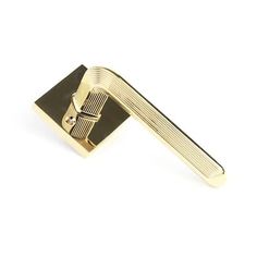 a gold door handle on a white background