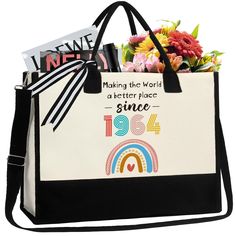 a black and white shopping bag with flowers in the bottom right corner, on a white background that says making the world a better place since 1950