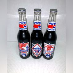 three pepsi soda bottles sitting next to each other