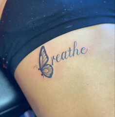 a woman with a butterfly tattoo on her stomach that says breathe and the words breathe are written in cursive font