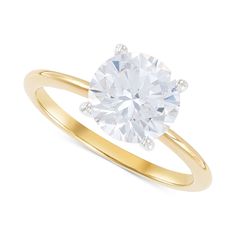 a yellow gold ring with an oval cut diamond