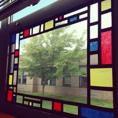 a stained glass window with trees in the background