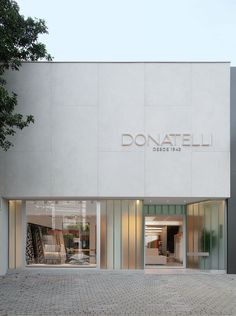 the front entrance to a store with glass doors on both sides and windows that say donatelli