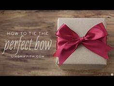 a present box with a red bow on it and the words how to tie the perfect bow