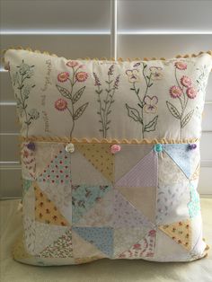 a pillow made with patchwork and flowers