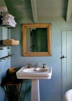 a white sink sitting under a mirror in a bathroom