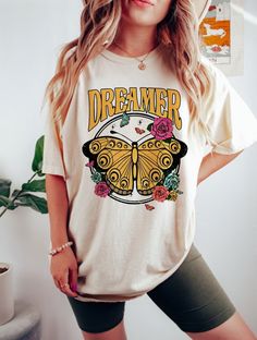 "♡\"Dreamer\" Retro Butterfly graphic tshirt ♡ 100% cotton cream color ♡ available in short sleeve or long sleeve, Bella & Canvas or Gildan ♡ One suits are available in Rabbit Skins brand or Hobby Lobby. NB one suits are going to be from hobby lobby & are TTS" Bad Moms Club, Retro Butterfly, Bad Moms, Retro Graphic Tees, Butterfly Graphic, Moms Club, Hobby Lobby, Vintage Tshirts, Lobby