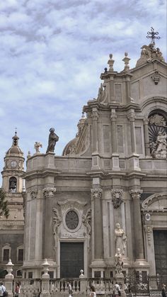 people are standing in front of an ornate building