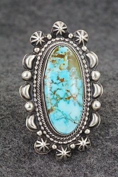 This beautiful Kingman turquoise and sterling silver ring was made by Navajo silversmith Tom Lewis. The back is signed and stamped sterling.Size: 7.5Length: 2"Width: 1 1/8"Free shipping on all orders! We ship with USPS and always include tracking. All orders ship within a day of payment.Returns are accepted up to 30 days after you receive your order. Just send us a message. Our shop offers cash back or store credit. The item must be returned in new condition. Western Sterling Silver Turquoise Ring With Patina, Western Sterling Silver Turquoise Concho Ring, Western Sterling Silver Turquoise Ring, Tom Lewis, Kingman Turquoise, Turquoise Sterling Silver, Sterling Silver Ring, Silver Ring, Sterling Silver Rings