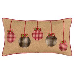 a burlocked pillow with ornaments hanging from it's sides on a white background