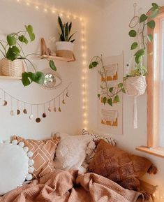 a bedroom with plants and lights on the wall