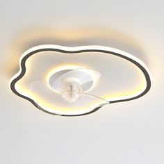 a white ceiling light with a circular design on the top and an electric cord attached to it