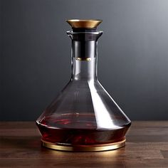 a glass decanter sitting on top of a wooden table