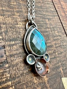 Labradorite is a beauty of a gem! It’s iridescent colors are amazing. It’s no wonder it’s know for sparking creativity! This mixed metal piece feature hand formed flowers of copper and silver with brass adornments. This little beauty is 1” wide and almost 2” total length, it comes on a 20”sterling silver necklace. Hand Forged Silver Jewelry In Mixed Metal, Unique Flower-shaped Metal Jewelry, Unique Flower Shaped Metal Jewelry, Unique Metal Flower Jewelry, Handmade Fusion Copper Jewelry, Handmade Copper Fusion Jewelry, Unique Mixed Metal Jewelry As Gift, Unique Mixed Metal Jewelry For Gifts, Silver Copper Jewelry Hand Forged