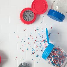 red, white and blue sprinkles are spilled out of a plastic cup