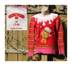 Vintage Red Christmas Hand Embroidered Gingerbread Sweater by Holiday Time      Be ready for the season, and make a big hit at your next Holiday party.  Layer up for that great Christmas look,  Great with cutoffs, jeans, skirts, and boots.   DESCRIPTION DESIGNER------ Holiday Time STYLE ----------- Casual  Crew Neck HEM-------------- 2 1/2 inch rib knit  DETAIL----------                                              ( HAND EMBROIDERED )                                     CLOSER--------  Crew Nec Gingerbread Sweater, Red Christmas Party, Skirts And Boots, Vintage Red Christmas, Christmas Party Sweater, Tacky Christmas Sweater, Tacky Christmas, Party Sweaters, Vintage Clothing Men