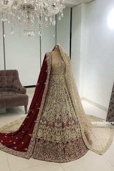 a bridal gown on display in front of a chandelier