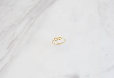 "✦Dainty Gold Infinity Ring! BAND DETAILS ✦Infinity sign is 0.42\"(approx.10.78mm) x 0.18\"(approx.4.79mm) ✦Band's thickness is 0.046\" (inches) or approx. 1.19mm. MATERIALS ✦Available in 9K and 14K and also in Yellow Gold,Rose Gold or White Gold. ✦Ring will be shipped in a jewelry box and bag. ✦IMPORTANT NOTE! All import duties and taxes are the buyer's responsibility, this is not calculated in the price. ✦We ship worldwide with FeDex,so please message us with your telephone number. R E T U R N Handmade Minimalist Infinity Rings, Minimalist Handmade Infinity Rings, Simple Gold Ring, Gold Infinity Ring, Geometric Symbols, Karma Necklace, Friendship Symbols, Infinity Sign, Gold Rings Simple