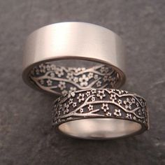 two wedding bands with intricate designs on them