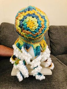 a crocheted object sitting on top of a couch