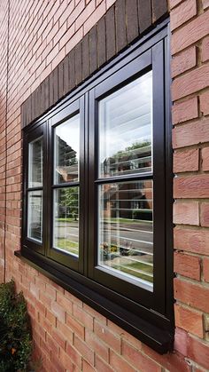 a brick building with a black window on the side