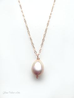 "Champagne Pink Freshwater Pearl Necklace ~ Available in 100% 14k gold fill, rose gold fill or sterling silver Capture the beauty of genuine pearls with this simple, elegant pearl drop necklace. ~ Genuine freshwater pearls have a gorgeous luster and the most beautiful champagne blush pink ~ Chain is a dainty and sparkly 14k gold fill, sterling silver or rose gold fill ~ Necklace closes with a spring clasp ~ Shown on model at 18\" length ~ Necklace is handcrafted, made to order, and packaged for Rose Gold 14k Gold Necklace With Pearl Pendant, Formal Rose Gold Briolette Necklace, Pink Briolette Jewelry For Wedding, Rose Gold Teardrop Necklace With Pearl Pendant, Delicate Rose Gold Jewelry With Pearl Pendant, Rose Gold Pearl Drop Necklace For Anniversary, Delicate Rose Gold Pear-shaped Jewelry, Dainty Rose Gold Briolette Necklace, Rose Gold 14k Gold Briolette Necklace