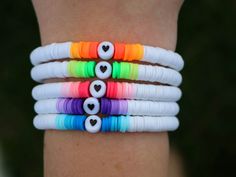 several bracelets with different colors and hearts on them