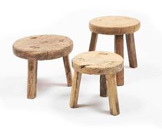 three wooden stools sitting next to each other