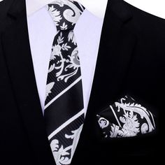 Black, Grey and White Floral Necktie Imagine yourself dressed in a sleek and stylish suit, ready to make a statement at your next formal event. Your ensemble is complete with a stunning black, grey, and white floral necktie and a coordinating black and silver geometric pocket square. The necktie is a work of art, beautifully crafted from the finest materials to create a mesmerizing floral pattern. The black background serves as the perfect canvas for the delicate, yet bold, blooms in shades of g White Standard Tie For Black Tie Events, White Business Ties With Pocket Square, Classic White Neckwear For Black Tie Events, Classic White Neckwear For Black Tie, White Pocket Square For Business Suit Accessories, White Pocket Square For Business Suit, Classic White Neckwear For Business, White Pocket Square For Black Tie Events, Elegant Patterned Ties For Formal Occasions