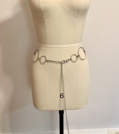 Ring and chain belt in silver tone. Only one available. Vintage belt. Large size. Waist/hips belt. Low slung belt. 44 inches.  Product details: 44 inches from clasp to clasp Size Large (please know your measurements before ordering)  Mannequin is size 6 USA (Waist 25 1/2 hips 35 1/2) Silver plated metals Please visit my shop for more goodies! https://www.etsy.com/shop/AnEnchantingCreature  VISIT MY SHOPS HERE   * http://www.etsy.com/shop/HappyCatHouse * http://www.Etsy.com/shop/AnEnchantingCreat Adjustable Metal Party Belt, Adjustable Metal Waist Chain Belt, Trendy Silver Chain Belt With Chain Strap, Silver Metal Waist Chain With Chain Strap, Metal Chain Belt With Belt Loops For Party, Metal Chain Link Belt With Belt Loops, Silver Chain Link Waist Chain For Party, Adjustable Silver Metal Chain Belt, Trendy Silver Belt For Party