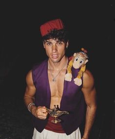 a man in costume holding a stuffed animal