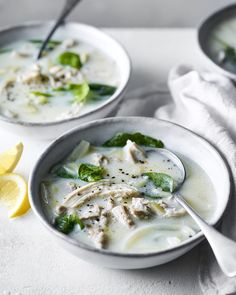 two bowls filled with soup next to a lemon wedge