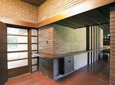 an empty room with a brick fireplace in it