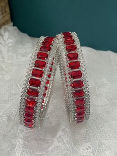 American diamond bangle/bracelet in Silver . About one inch wide. Colored stone work Formal Crystal Bracelets With Stones, Crystal Bangle Bracelets As Gift, Stackable Diamond Cuff Bangle Bracelet, Stackable Diamond Cuff Bracelet Bangle, Red Round Bracelets With Diamond Accents, Red Bracelets With Diamond Accents, Formal Stackable Ruby Jewelry, Stone Bangle Jewelry For Parties, Party Bangle Jewelry With Stones