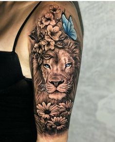 a woman's arm with a lion and flowers on it